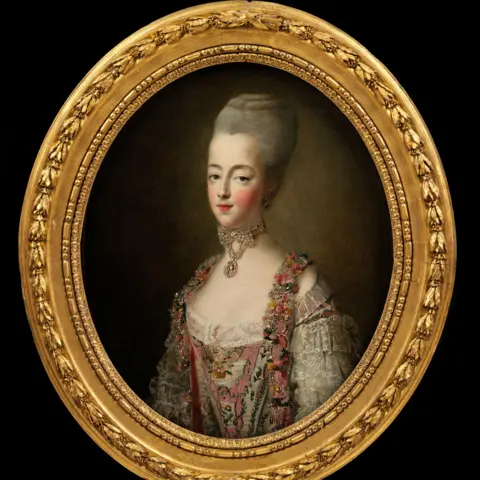 Sotheby's An oval-framed painted portrait of Marie Antoinette wearing a pink and white floral gown with lace and jewel embellishments, and a high powdered hairstyle