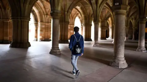 Getty Images A student walks through the cloisters of Glasgow University