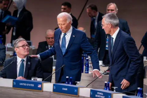 SHAWN THEW/EPA US President Joe Biden stands between Nato secretary general Jens Stoltenberg and UK prime minister Keir Starmer at the Nato anniversary summit in Washington