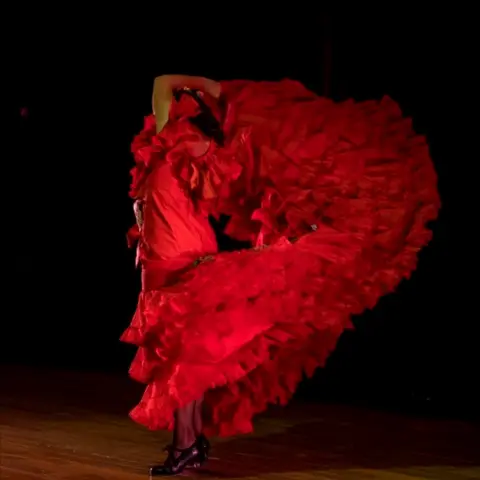 JALAL MORCHIDI/EPA Spanish flamenco dancer Maria Moreno spins in a red, ruffled flamenco dress.