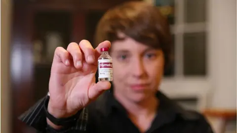 Getty Images Laura Marston shows the insulin she needs to live