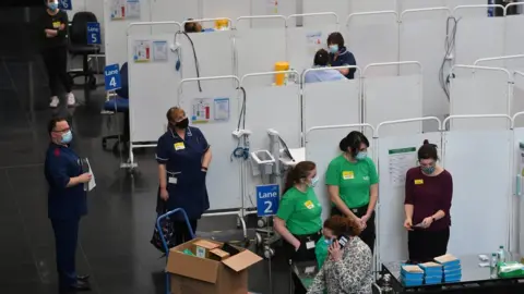 EPA Members of staff prepare to administer injections of a Covid-19 vaccine at the NHS vaccine centre that has been set up at the Millennium Point centre in Birmingham