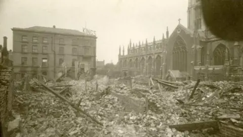 Hull Museums Archive image of Holy Trinity Church with piles of rubble in front left by bomb damage