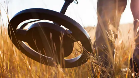 Getty Images Man using metal detector