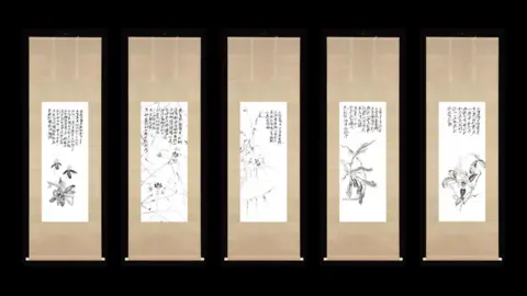 Zheng Bo Five hanging scrolls show delicate ink orchids and flowing calligraphy. They are in front of a black background.
