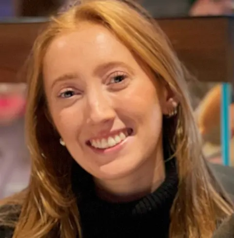Supplied Close up of Chloe Moffat, who has long, red hair, smiling at the camera.
