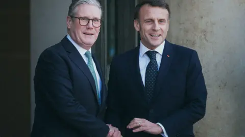 Getti, Sir Kerr Starmer, shake Emmanuel Macron's hand, outside the Elzi Palace