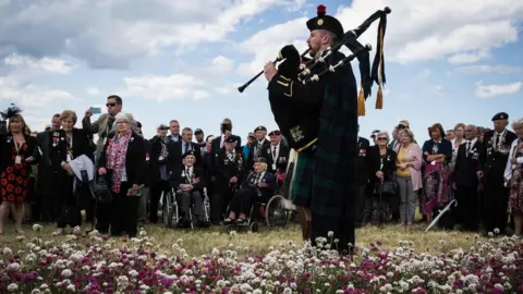 AFP A British soldier played the bagpipes for the inauguration of a garden in Arromanches