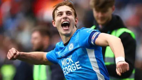 Hector Kyprianou celebrates following Peterborough United's win over Birmingham City in the EFL Trophy final at Wembley in April