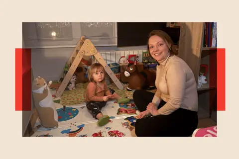 Oksana and her young daughter pictured playing with toys at home