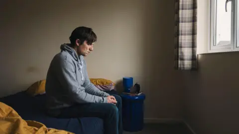 Justin Paget/Getty Images A man sitting alone in his bedroom