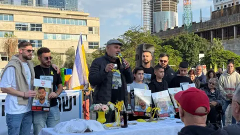 BBC Itzik Gvili, father of the last dead Israeli hostage in Gaza, Ran Gvili, speaks to supporters at Hostages Square, Tel Aviv, Israel (12 December 2025)