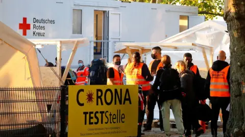 Reuters travellers returning from Kosovo are tested at berlin bus station