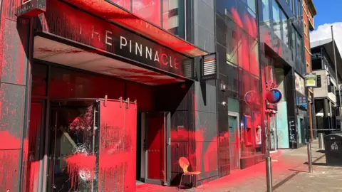 BBC / Elizabeth Baines The Pinnacle building in Leeds covered in red spray paint