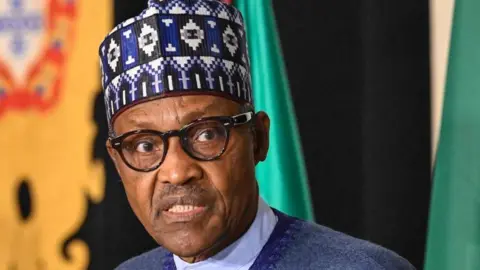 Former Nigeria president Muhammadu Buhari with wearing eye glasses and a traditional hat