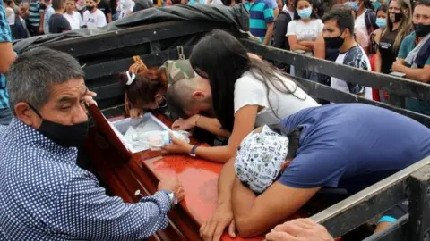 EPA Family members bid farewell to one of the victims of the murder of eight people in Samaniego, Colombia, 16 August 2020.