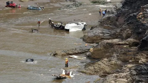 PA Media Boscastle flood August 2004: Emergency services at the scene, after a wall of water tore through the picturesque tourist spot of Boscastle in north Cornwall