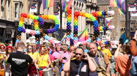 Jon Foster Cardiff Headshots A general view of the Pride balloon sign with a crowd surrounding it. 