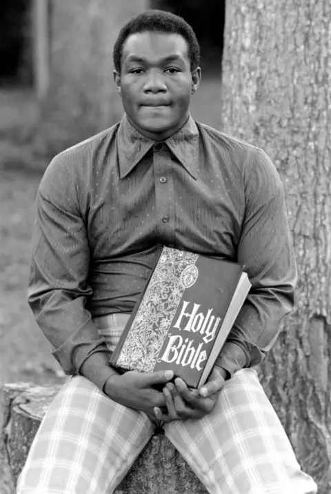 Michael Brennan/Getty Images of Foreman Holding Bible