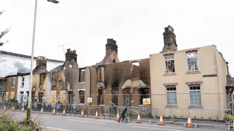 A row of fire damaged terraced houses in Wennington.