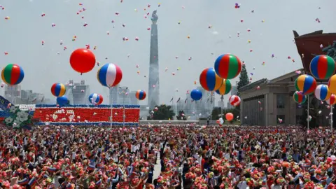 Sputnik / Getty Images In this pool photograph distributed by the Russian state agency Sputnik, people release balloons in the air as Russia's President Vladimir Putin and North Korea's leader Kim Jong Un attend a welcoming ceremony at Kim Il Sung Square in Pyongyang on June 19, 2024.