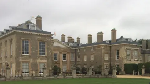 Martin Heath/BBC Three storey stone-built mansion with lawn in the foreground