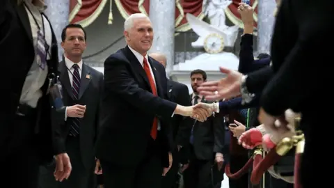 Getty Images US Vice-president Mike Pence head to vote on tax reform, 19 December