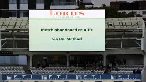 Getty Images A screen at Lord's cricket ground showing the match was abandoned as a tie via D/L method