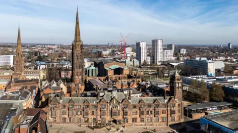 Aerial view of Coventry city center showing the ruins of the old cathedral, the new cathedral and the Council House.