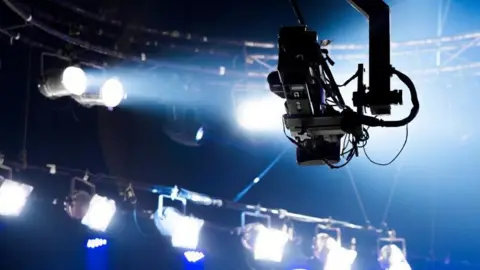 TV studio lights and cameras.