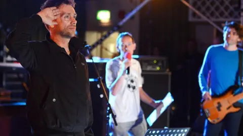 Damon Albarn, BBC broadcaster Steve Lamacq and Alex James