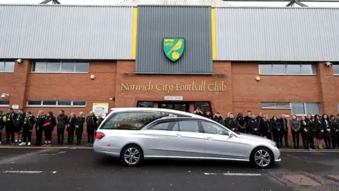 Norwich City FC The funeral cortege was met outside Carrow Road by club staff and fans.