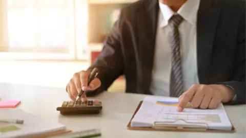 Getty Images Man with calculator