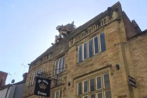 The boar's head on top of Ye Olde Crown pub