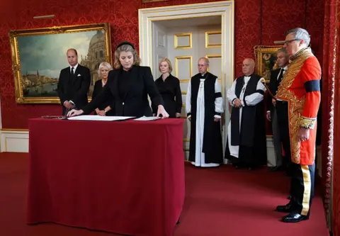 Kirsty O'Connor/Pool via REUTERS Lord President of the Council Penny Mordaunt signs the Proclamation of Accession