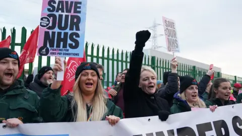 PA Media Striking ambulance workers on a picket line in Coventry with Unite general secretary Sharon Graham