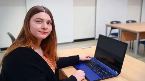 Charlotte Worthington Alice Bate teaching in an empty classroom.