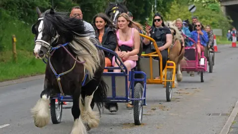 PA Media Convoy of horse and traps