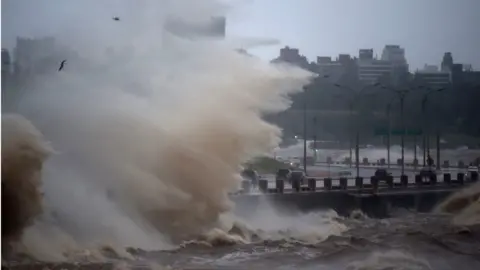 Waves crash over Montevideo's Rambla during the passage of a subtropical cyclone on May 17, 2022.