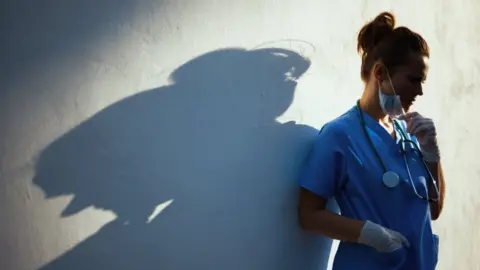 CentralITAlliance - Getty Doctor next to a wall