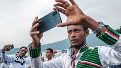 AFP People taking selfies during the Oromo thanksgiving holiday in Ethiopia - October 2021