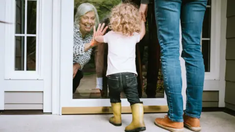 Getty Images Seeing child through a door