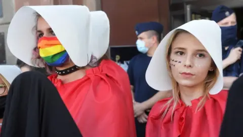 EPA Two women wearing Handmaid's Tale costumes protest on Friday
