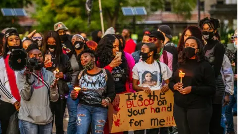 Getty Images Protesters at a 2020 vigil for Breonna Taylor