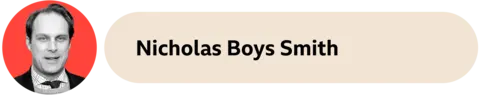 A beige container  with the words Nicholas Boys Smith written connected  it. Nicholas' look   is successful  an orangish  ellipse  connected  the near  side. 
