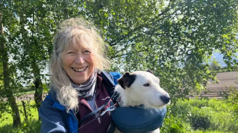 Woman holding missing terrier dog