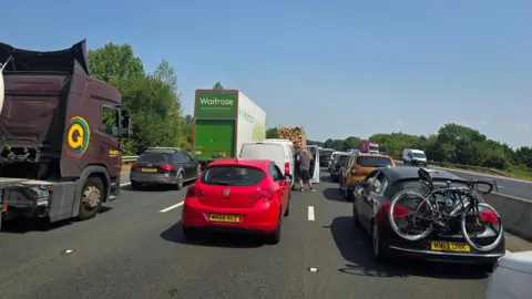Caroline Thorne Cars at a standstill on the M5 on a sunny day. 
