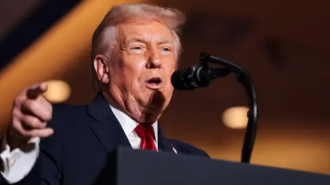 Reuters US President Donald Trump speaks into a microphone behind a podium at an event in Pennsylvania on 9 December.