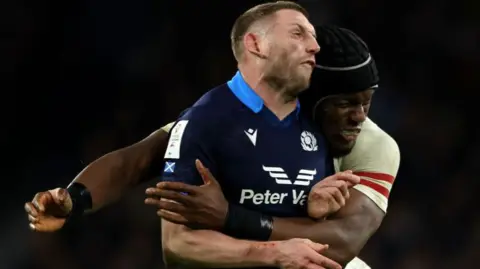 Finn Russell is tackled by Maro Itoje