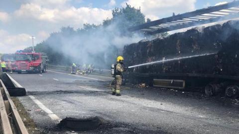 Firefighters tackle a lorry fire on the M42